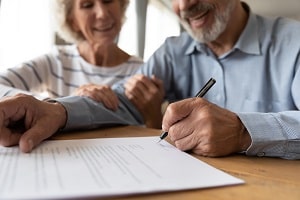Senior Couple signing estate planning documents